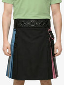 Person wearing a black kilt with colorful accents and a green shirt on a white background
