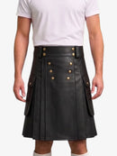 A black faux-leather kilt with gold-tone double-breasted buttons and side flap pockets, shown on a model wearing a white t-shirt against a light gray background.