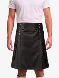 A black faux-leather kilt with silver-tone hardware, worn by a model in a white t-shirt against a light gray background.