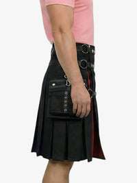 Black kilt with decorative elements worn by a person on a white background