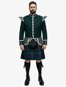 Man wearing a traditional Scottish black watch tartan kilt with a dark green doublet jacket on a white background
