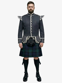 Man wearing a traditional Scottish black watch tartan kilt with a dark grey jacket on a white background
