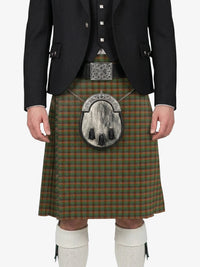 Person wearing a traditional Scottish kilt with a tartan pattern on a white background