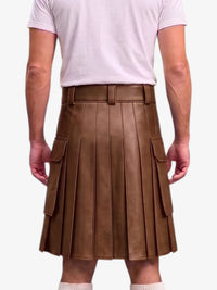 A person shown from the back wearing a brown pleated faux-leather kilt with side cargo pockets, paired with a light pink t-shirt and white socks, against a plain light gray background.