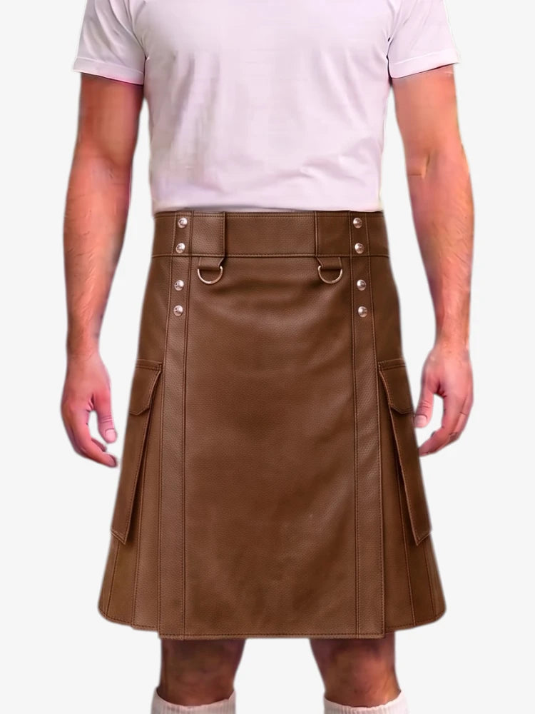 A man wearing a brown faux-leather kilt with silver-tone metal hardware and side cargo pockets, paired with a light pink t-shirt and white socks, against a plain white background.