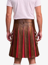 A man wearing a brown pleated leather kilt with red lining and decorative silver-tone buttons, paired with a white t-shirt, shown from the back against a light gray background.