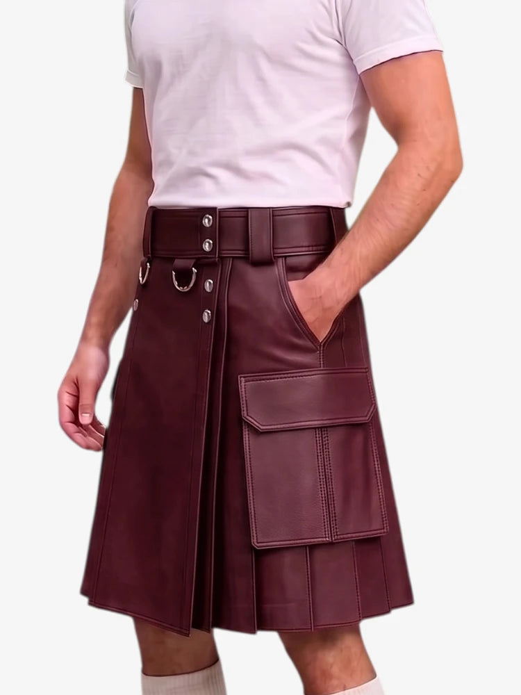 A maroon faux-leather kilt with a wide matching belt, silver-tone hardware, and large cargo pockets, shown on a model wearing a white t-shirt against a light gray background.