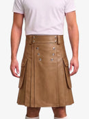 A model wearing a brown faux-leather kilt with silver-tone double-breasted buttons and side cargo pockets, paired with a white t-shirt and white socks, against a light gray background.