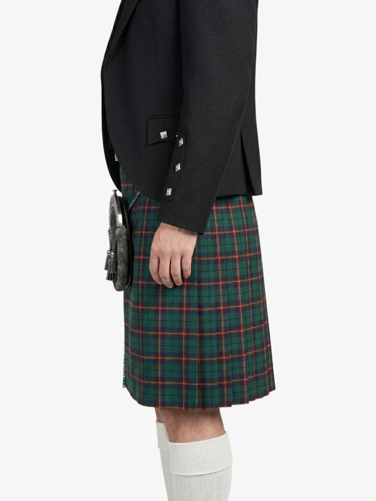 Person wearing a black blazer and green plaid kilt on a white background