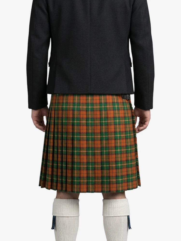 Person wearing a black jacket and green plaid kilt on a white background