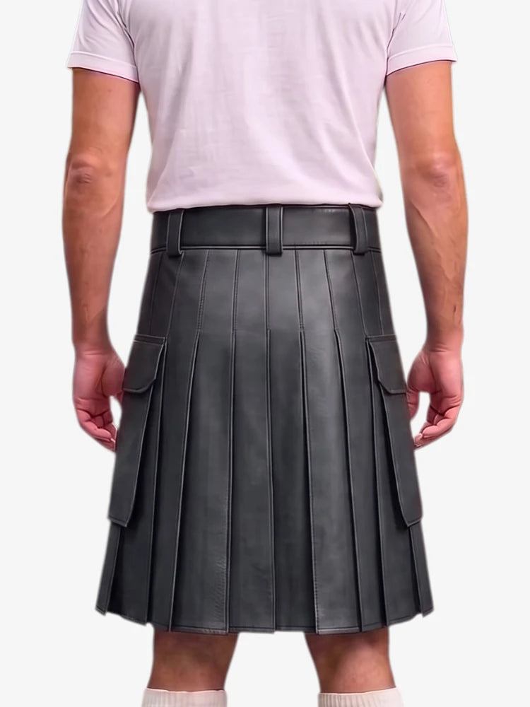 A person shown from the back wearing a dark gray pleated leather kilt with side cargo pockets, paired with a light pink t-shirt and white socks, against a plain light gray background.