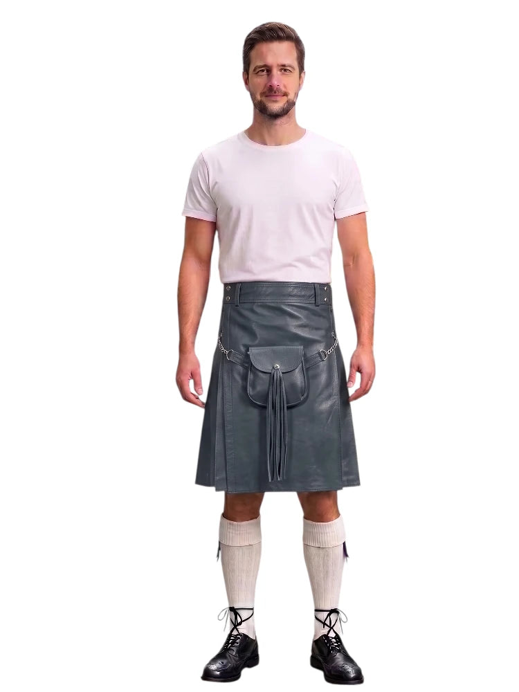A man modeling a dark gray faux-leather kilt with a front pouch pocket, paired with a white t-shirt, cream knee-high socks, and black lace-up shoes, against a solid white background.