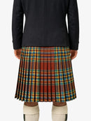 Person wearing a black jacket and plaid kilt on a white background