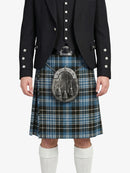 Person wearing a black jacket and blue plaid kilt on a white background
