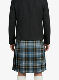 Person wearing a black jacket and plaid kilt on a white background