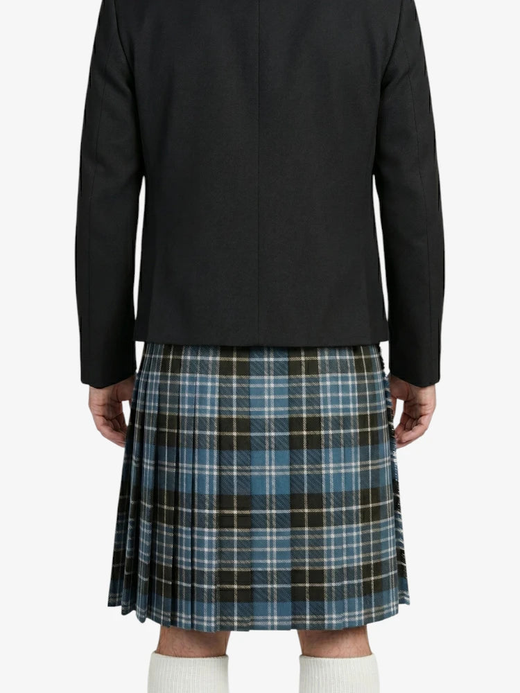 Person wearing a black jacket and plaid kilt on a white background
