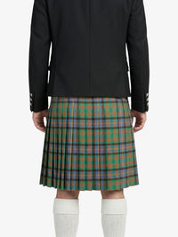 Person wearing a black jacket and green plaid kilt on a white background