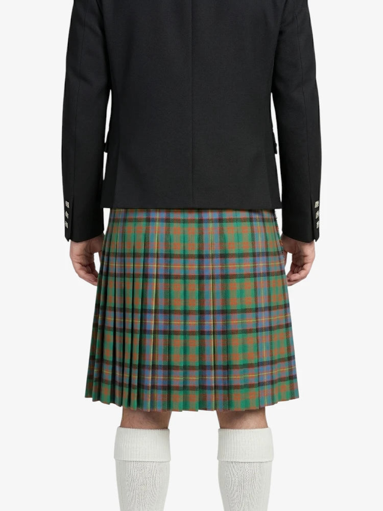 Person wearing a black jacket and green plaid kilt on a white background