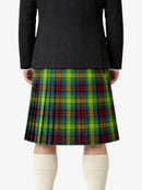 Person wearing a black jacket and a colorful plaid kilt on a white background
