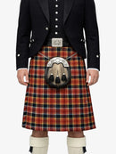 Person wearing a traditional Scottish kilt with a tartan pattern on a white background