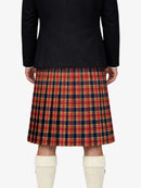 Person wearing a black jacket and red plaid kilt on a white background