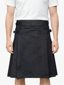 Person wearing a black denim skirt with a white shirt on a plain background