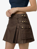 Brown skirt with gold buttons worn by a person on a white background