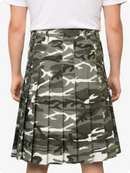 Camouflage pleated skirt worn by a person on a plain background