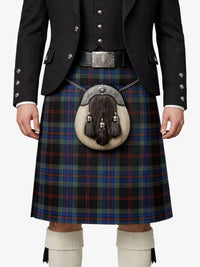 Person wearing a traditional Scottish kilt with a jacket and white knee-high socks on a white background