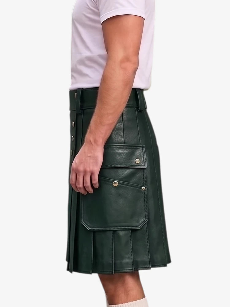 A dark green faux-leather kilt with pleated detailing and flap pockets, shown on a model wearing a white t-shirt against a light gray background.