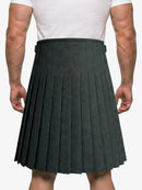 Person wearing a gray pleated kilt on a white background