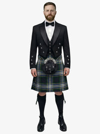Man wearing a traditional Scottish dress gordon tartan kilt with a black prince charlie jacket and bow tie on a white background