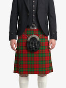 Person wearing a red tartan kilt with a black jacket on a white background