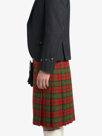 Person wearing a dark jacket and red plaid kilt on a white background