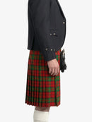 Person wearing a dark blazer and red plaid kilt on a white background