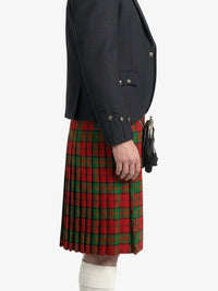 Person wearing a dark blazer and red plaid kilt on a white background