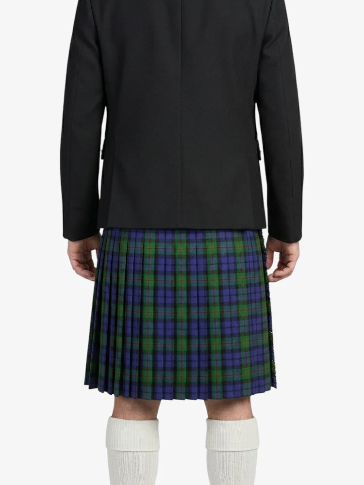 Person wearing a black jacket and plaid kilt on a white background
