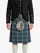 Person wearing a black jacket and blue plaid kilt with a silver sporran on a white background