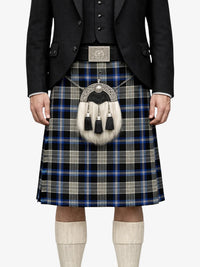 Person wearing a traditional Scottish kilt with a plaid pattern on a white background