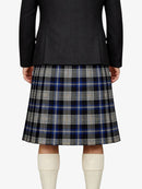 Person wearing a black jacket and plaid kilt on a white background