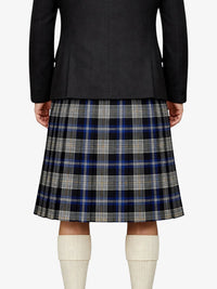Person wearing a black jacket and plaid kilt on a white background