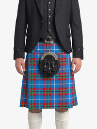Person wearing a blue plaid kilt with a black jacket on a white background
