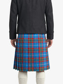 Person wearing a black coat and blue plaid kilt on a white background