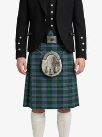 Person wearing a traditional Scottish kilt with a tartan pattern on a white background