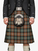 Person wearing a traditional Scottish kilt with a sporran on a white background