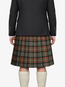 Person wearing a dark jacket and plaid kilt on a white background