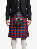 Person wearing a black jacket with silver buttons and a red and blue plaid kilt on a white background
