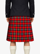 Person wearing a red plaid kilt with a black jacket on a white background