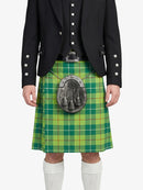 Person wearing a green plaid kilt with a black jacket on a white background