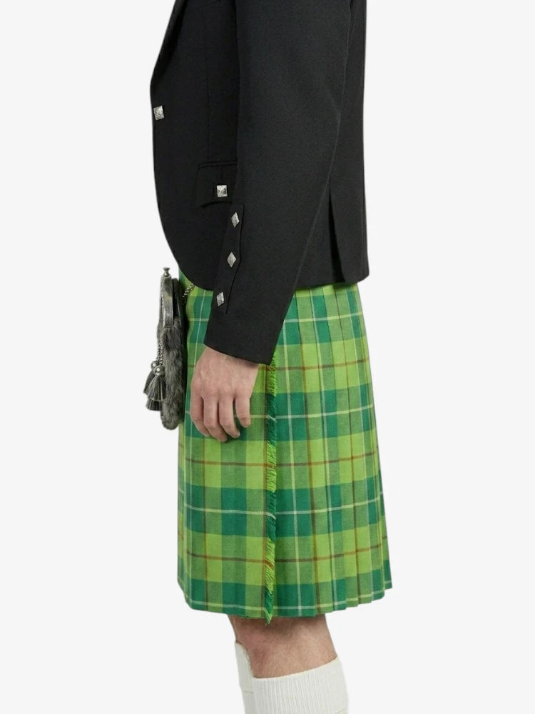 Person wearing a green plaid kilt with a black jacket on a white background